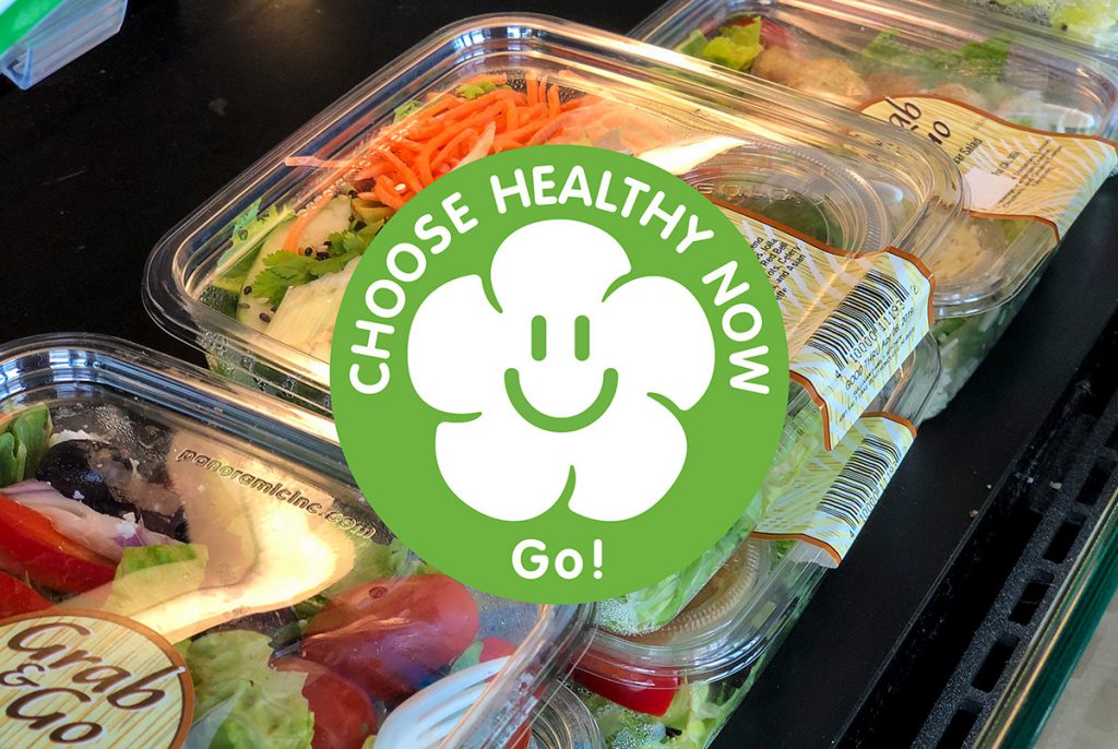 Closed platters of healthy meals with a sticker that reads 