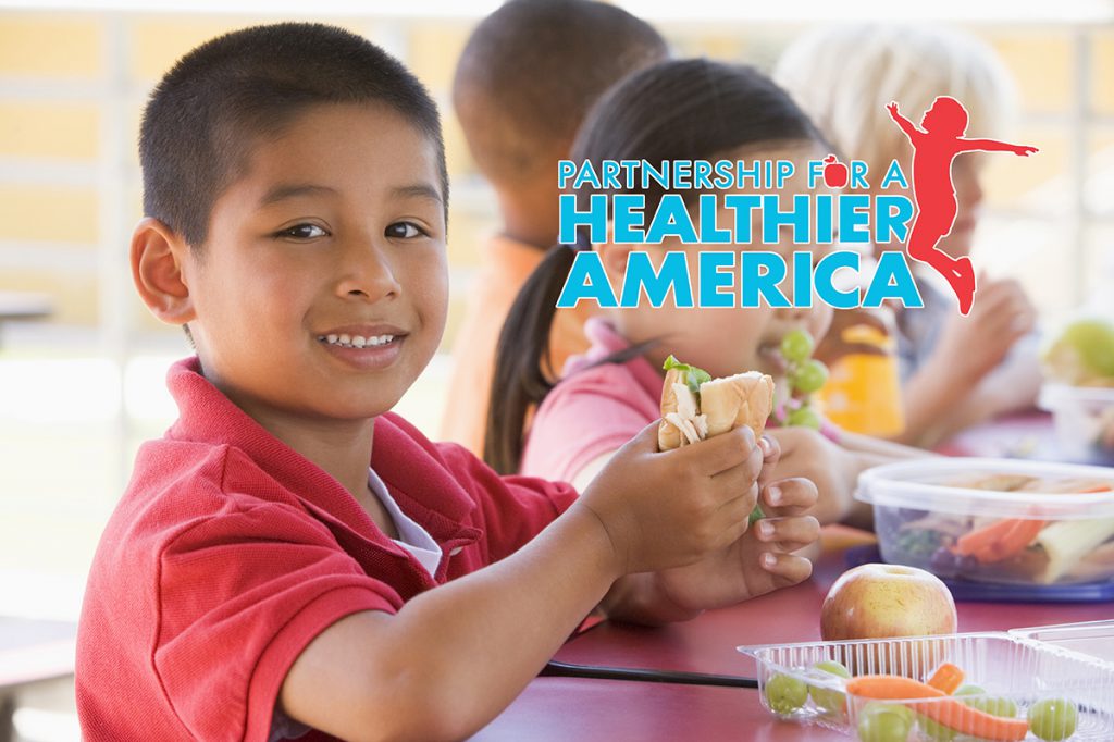 Children eating sandwiches and text that says partnership for a healthier america
